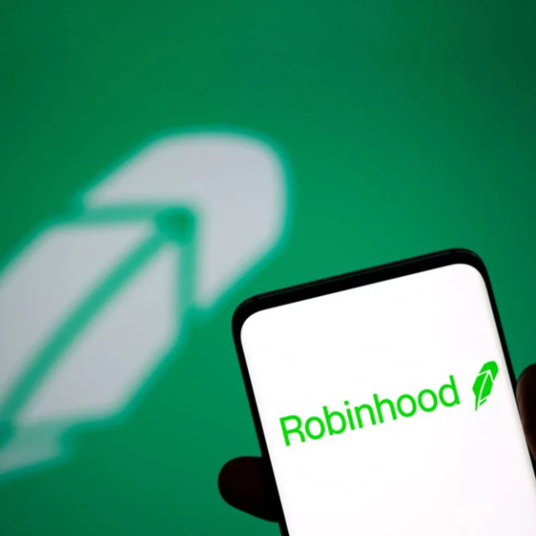A phone showing the Robinhood application with the Robinhood logo in the background.