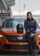 Driver Amna Al Qubaisi sitting on the Cadillac car.