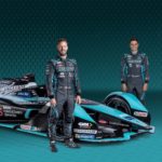 Jaguar drivers standing next to the car.