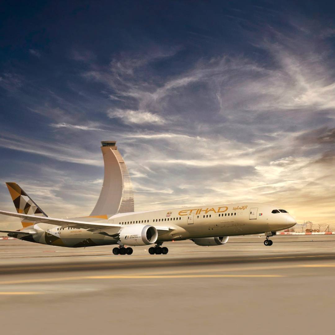 An Etihad Airways plane landing on the runway.